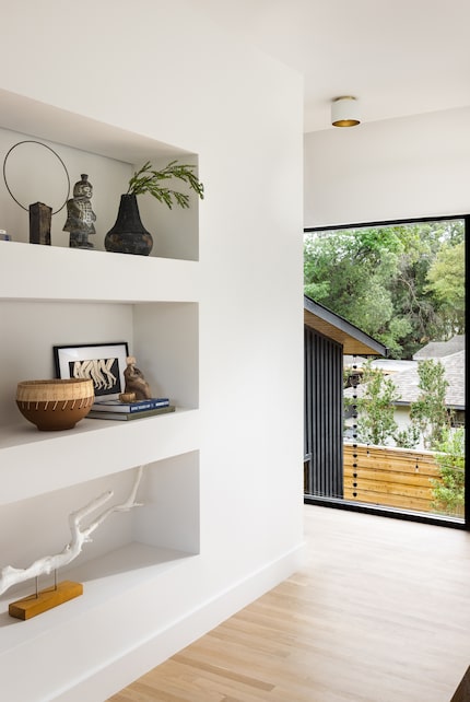 Built-in shelves contain books, baskets, artwork and sculptures from China.