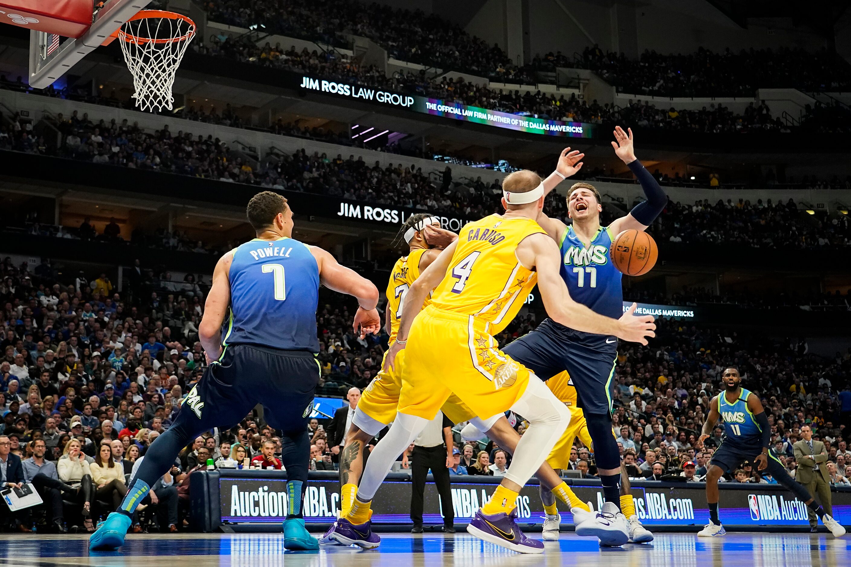 Dallas Mavericks guard Luka Doncic (77) loses the ball as he tries to drive to the basket...