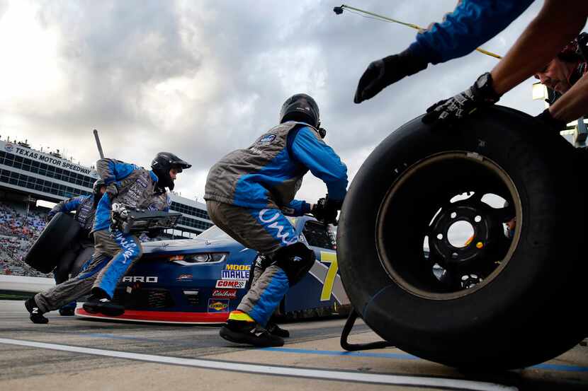 Crewman of NASCAR Xfinity Series driver Justin Allgaier make a four-tire change on the No. 7...