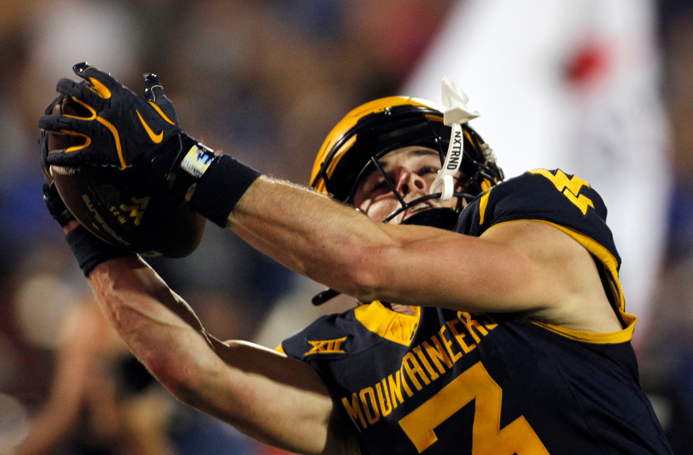 West Virginia receiver Hudson Clement (3) stretches to pull in a long touchdown reception in...