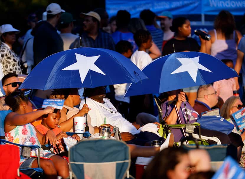 People kept cool under patriotic umbrellas during the Addison Kaboom Town! 4th of July...