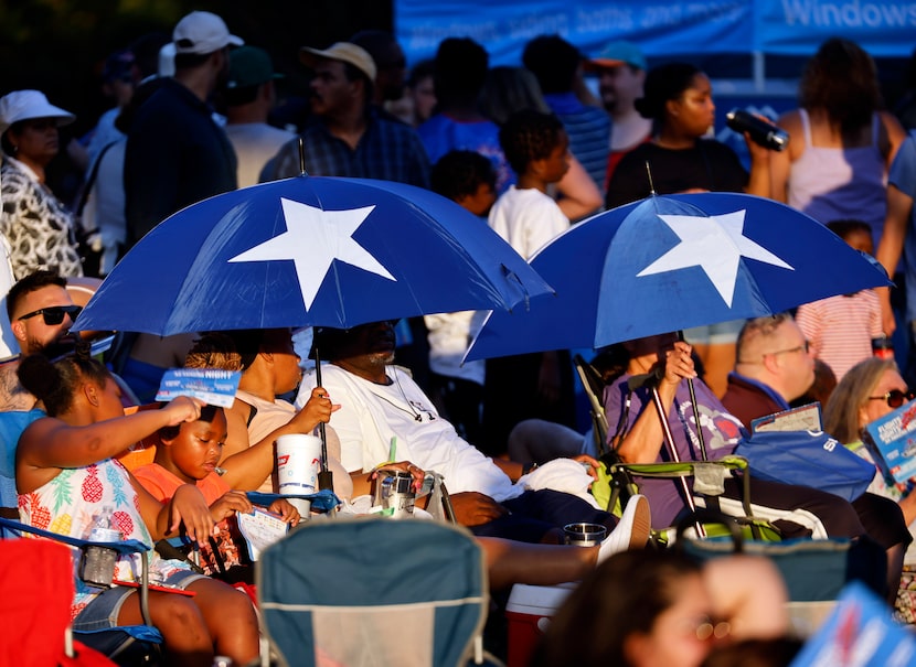 People kept cool under patriotic umbrellas during the Addison Kaboom Town! 4th of July...