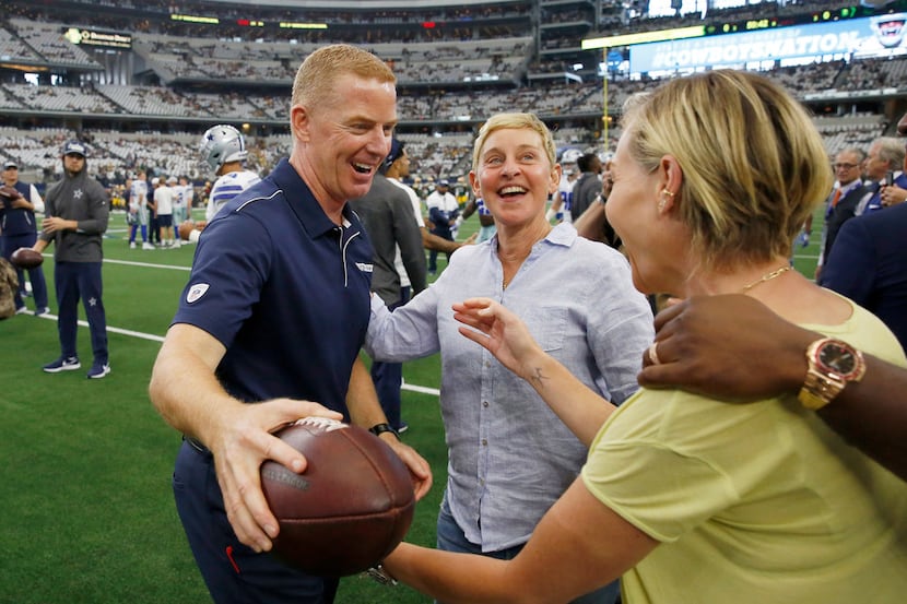 Dallas Cowboys head coach Jason Garrett hugs Portia de Rossi as her spouse Ellen DeGeneres...