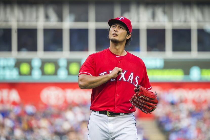 Texas Rangers starting pitcher Yu Darvish pounds his fist into his chest after retiring the...