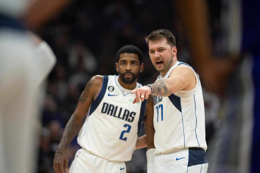 Dallas Mavericks guard Kyrie Irving (2) listens to guard Luka Doncic (77) in the first...