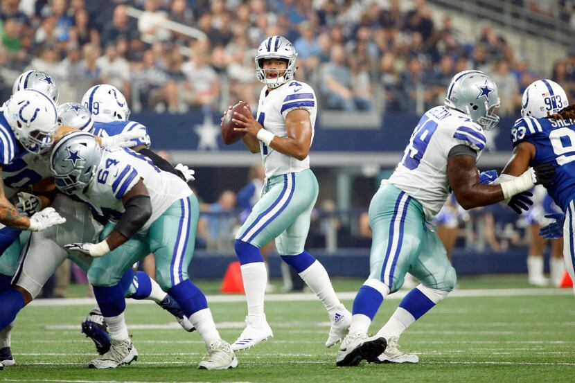 Dallas Cowboys quarterback Dak Prescott (4) looks for an open receiver during the first half...