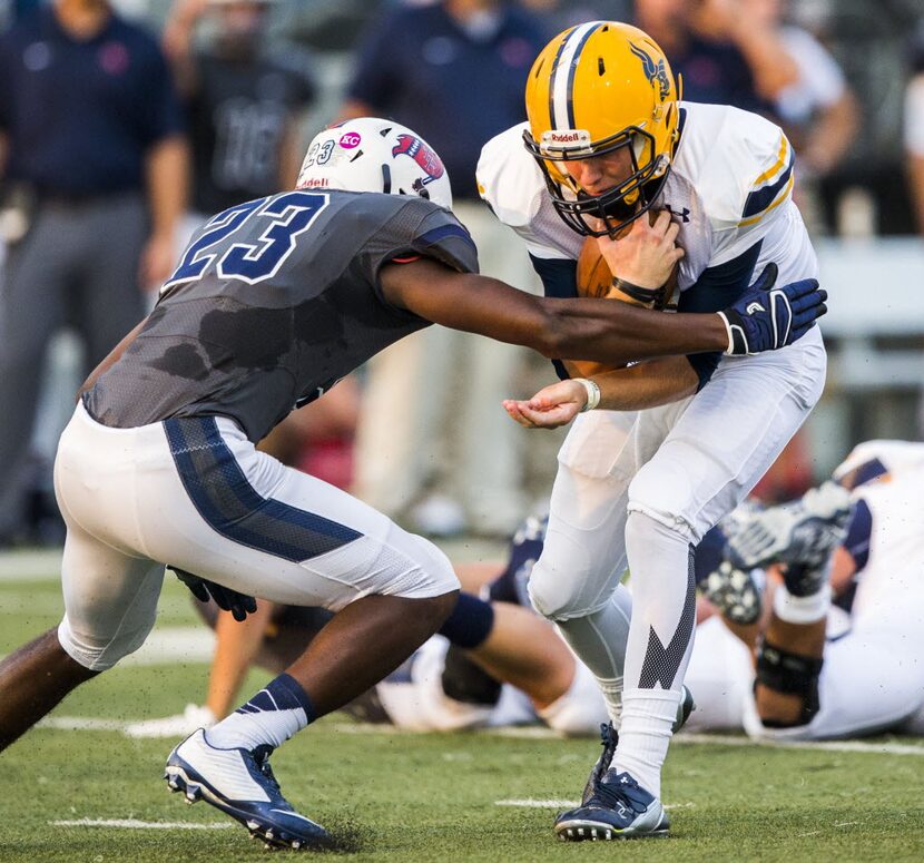 Arlington Lamar High School quarterback Shane Buechele (7) is tackled by Richland High...