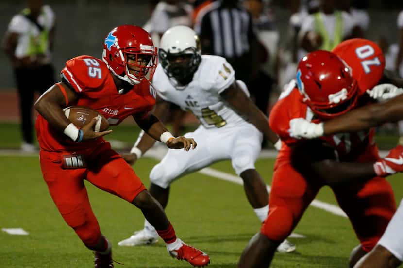 Skyline running back Javius Williams (250 tries to get past South Oak Cliff defenders during...