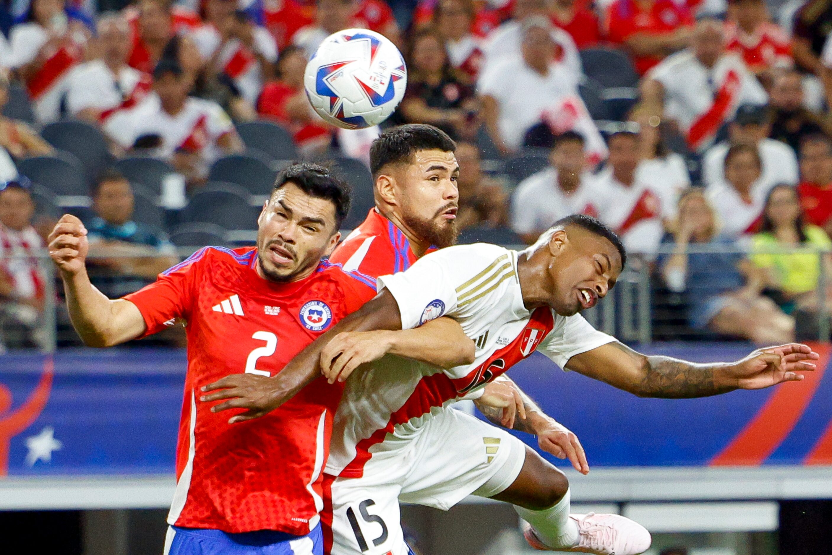 Chile defenders Gabriel Suazo (2) and Paulo Díaz (5) and Peru defender Miguel Araujo (15)...