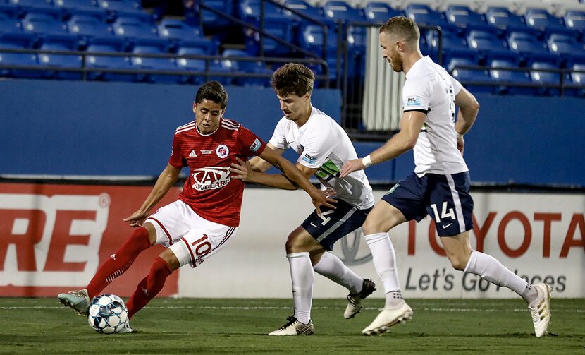 Arturo Rodriguez, USL-1 Final MVP, shields off two Greenville defenders in the USL League...