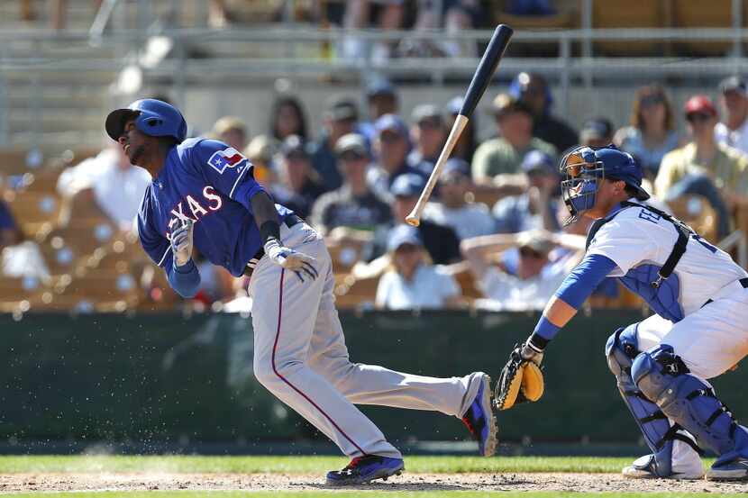 Texas Rangers Jurickson Profar throws his bat as Los Angeles Dodgers catcher Tim Federowicz...