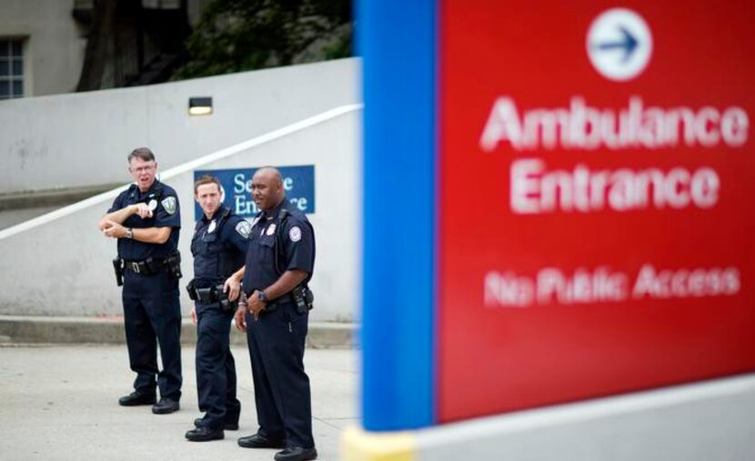 
Police officers guarded an entrance to Emory University Hospital after Dr. Kent Brantly...