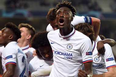 Chelsea's Willian, center, is mobbed by his teammates including Tammy Abraham, right, after...
