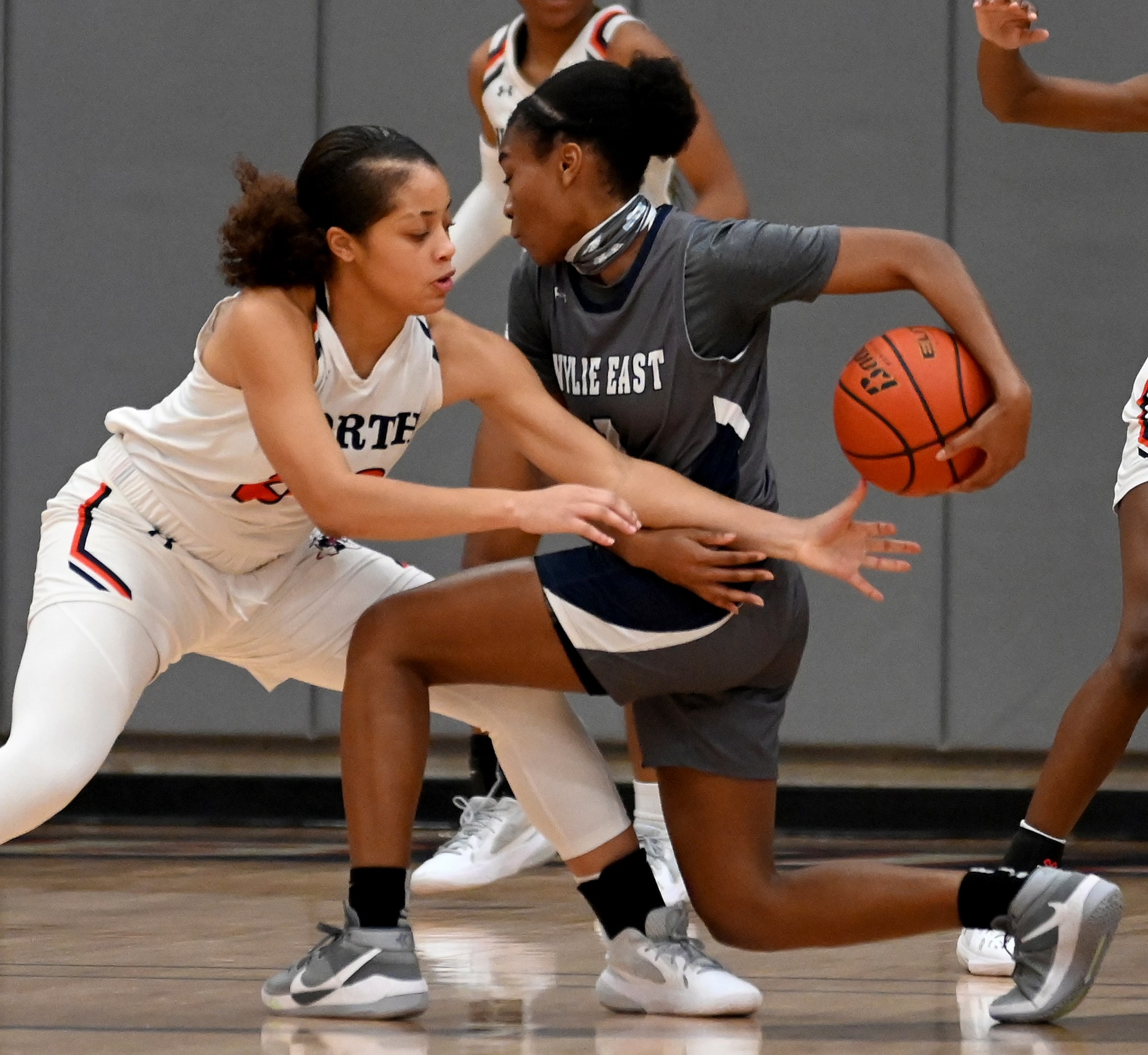 McKinney North’s Jayden Smallwood knocks the ball away from Wylie East’s Taylor Dailey...