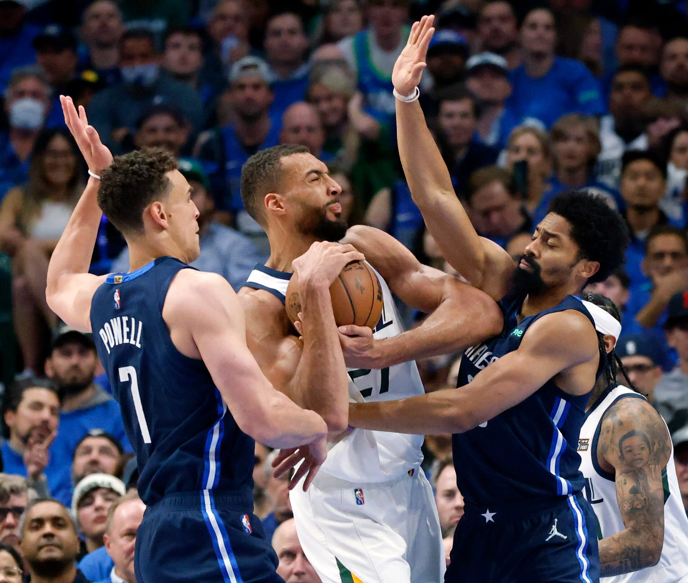 Utah Jazz center Rudy Gobert (27) is tightly covered by Dallas Mavericks center Dwight...