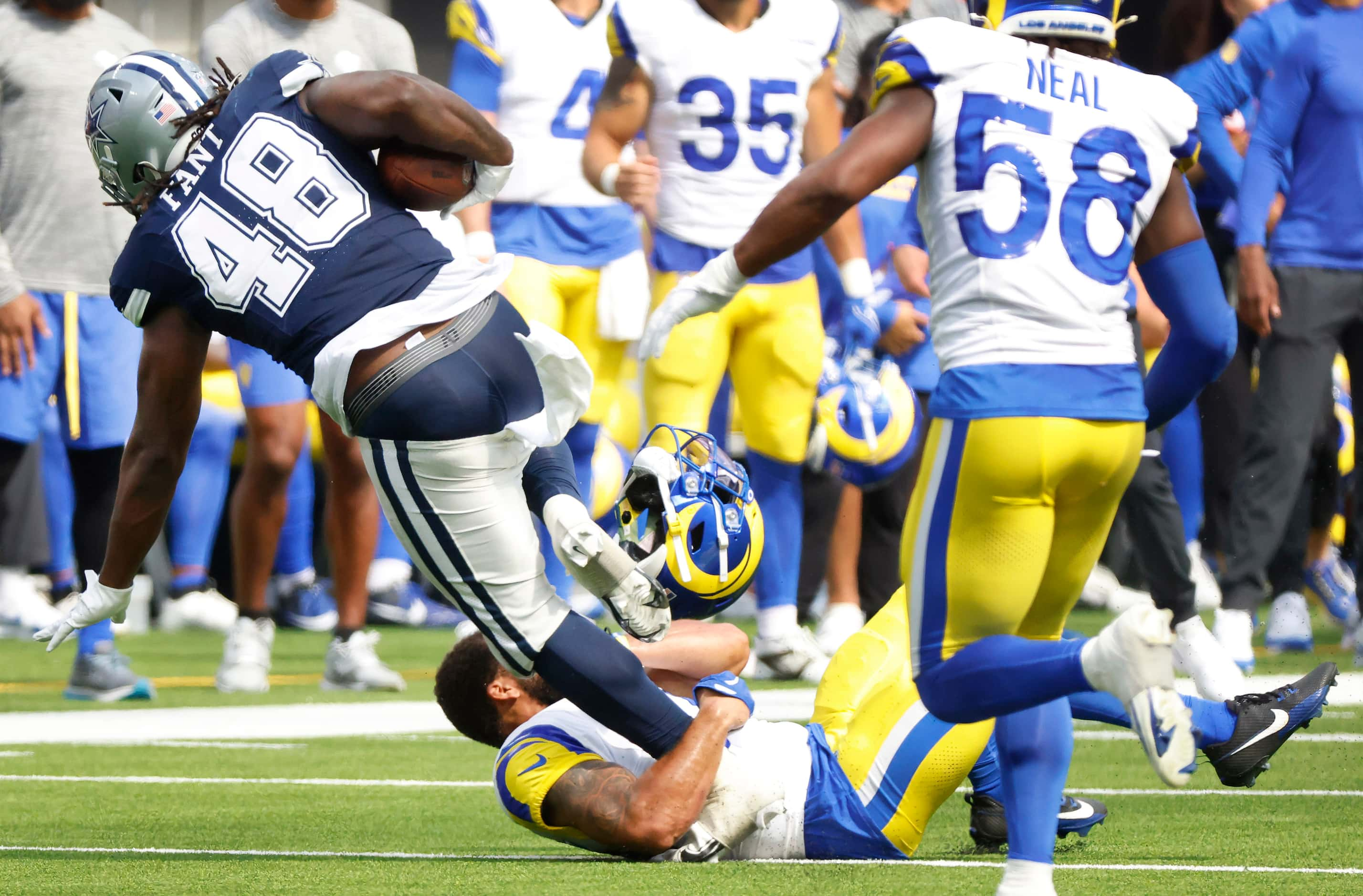 Los Angeles Rams safety Tanner Ingle (34) looses his helmet as he pulls down the pants of...