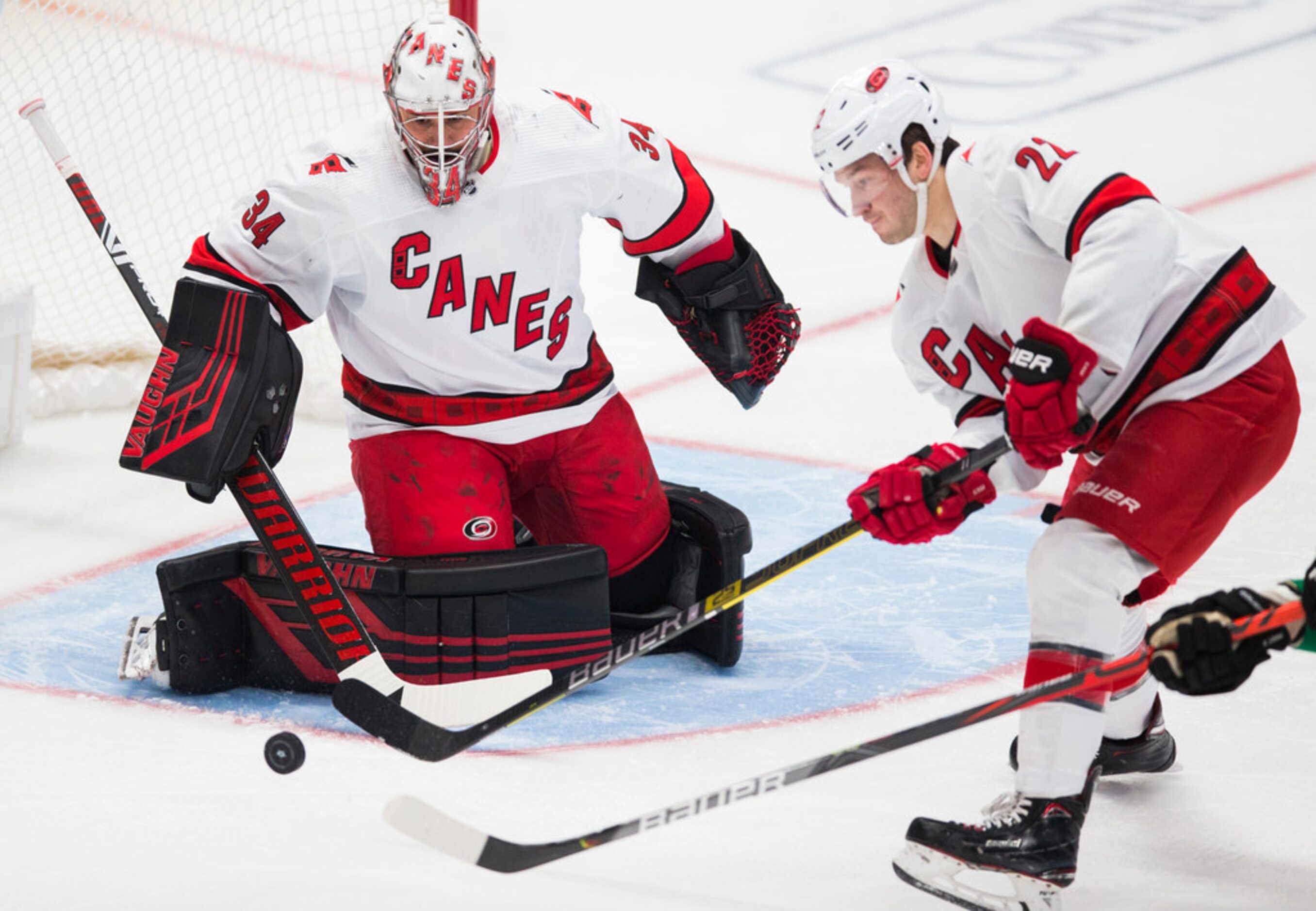 Carolina Hurricanes left wing Brock McGinn (23) and goaltender Petr Mrazek (34) keep the...