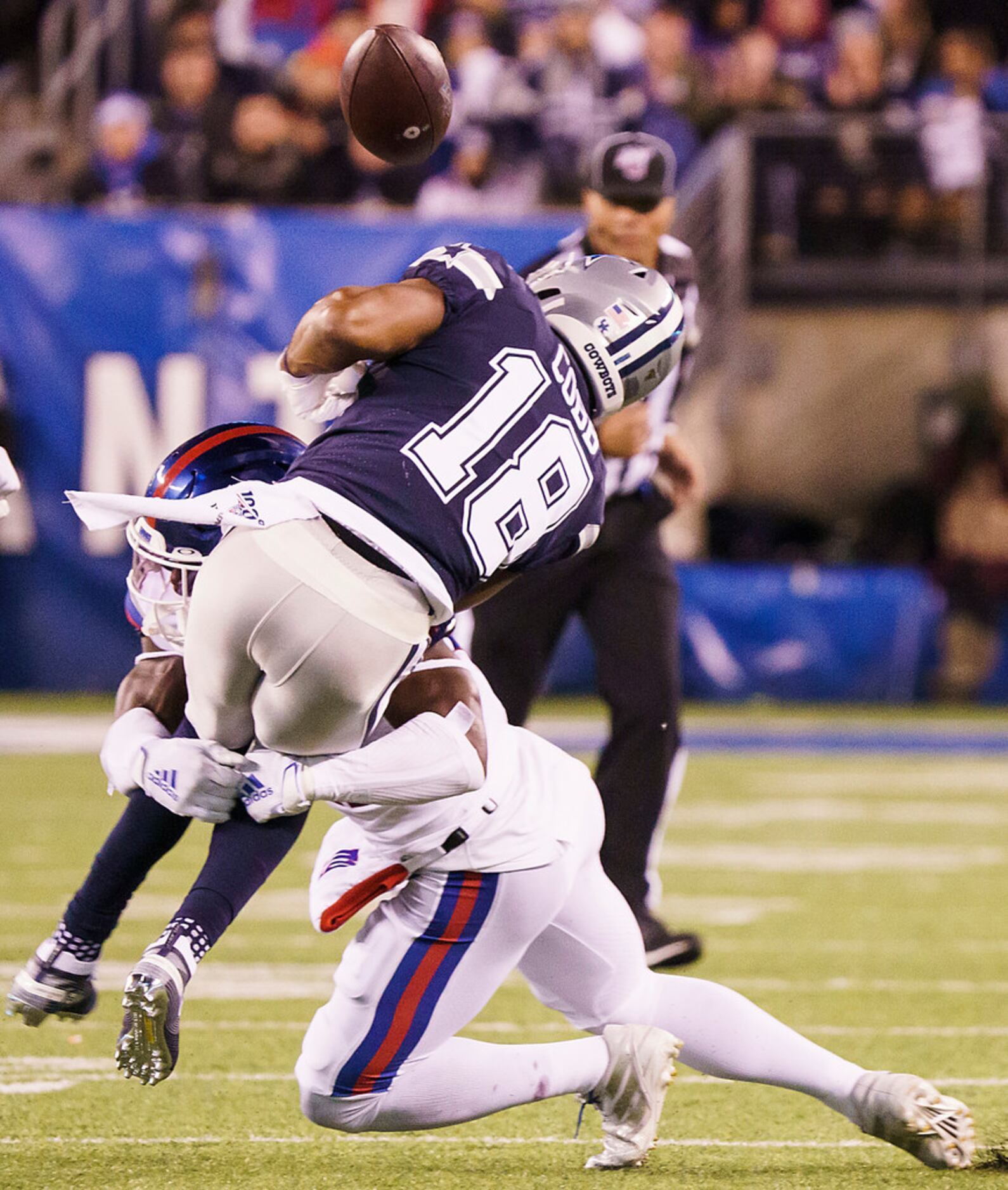 Dallas Cowboys wide receiver Randall Cobb (18) fumbles as he is hit by New York Giants free...