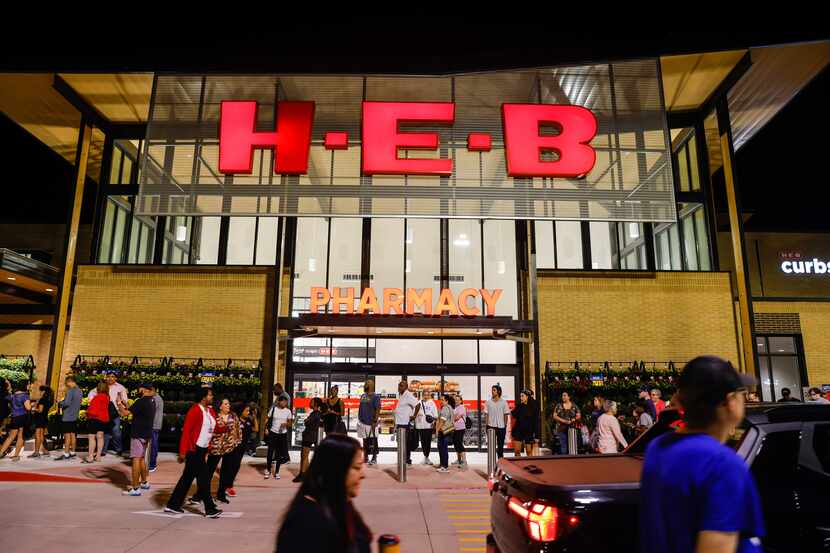 People wait outside the new H-E-B store set to open at 6AM in Frisco on Wednesday, Sept. 21,...