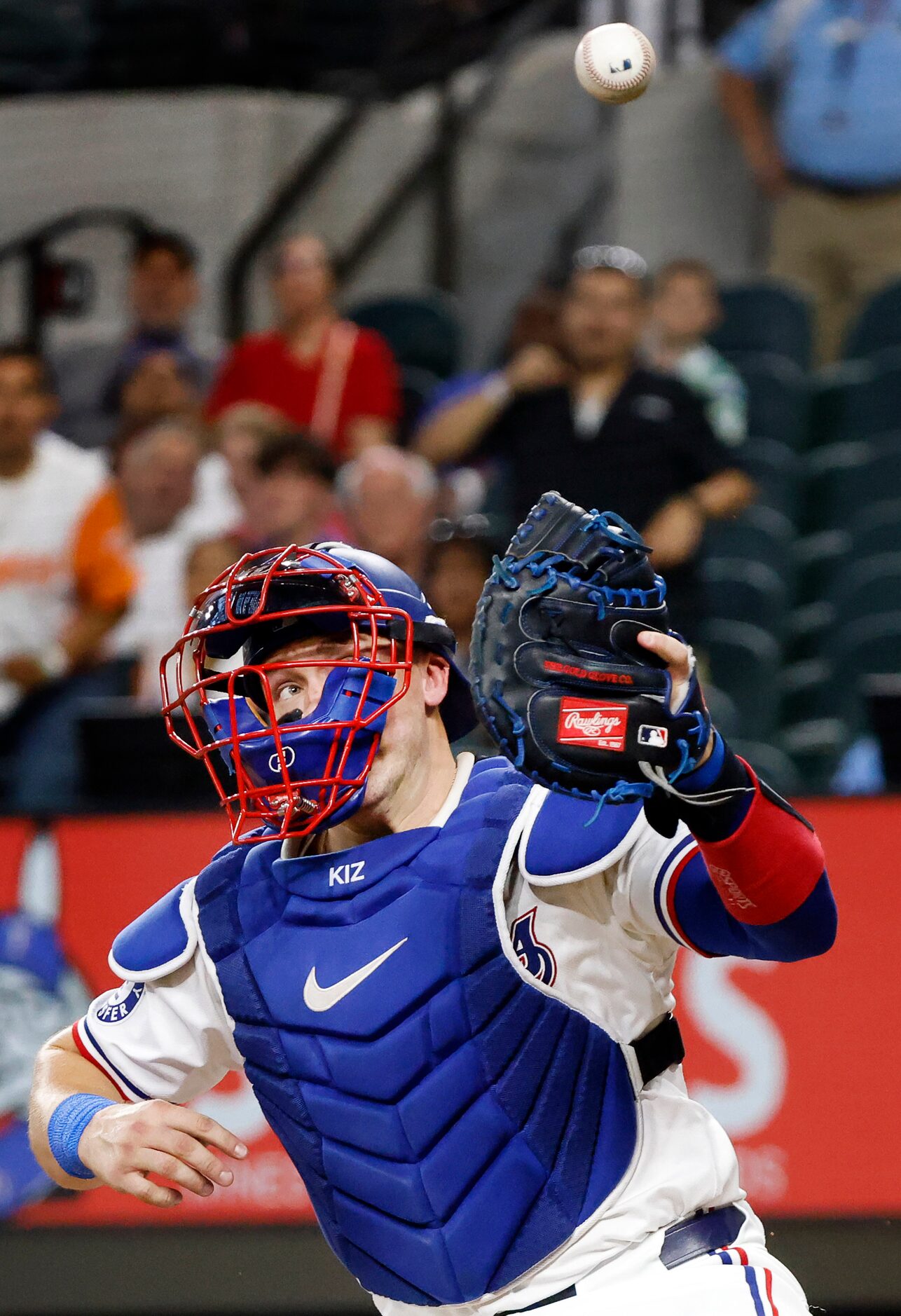 Texas Rangers catcher Andrew Knizner (12) has the throw in from centerfield bounce off his...