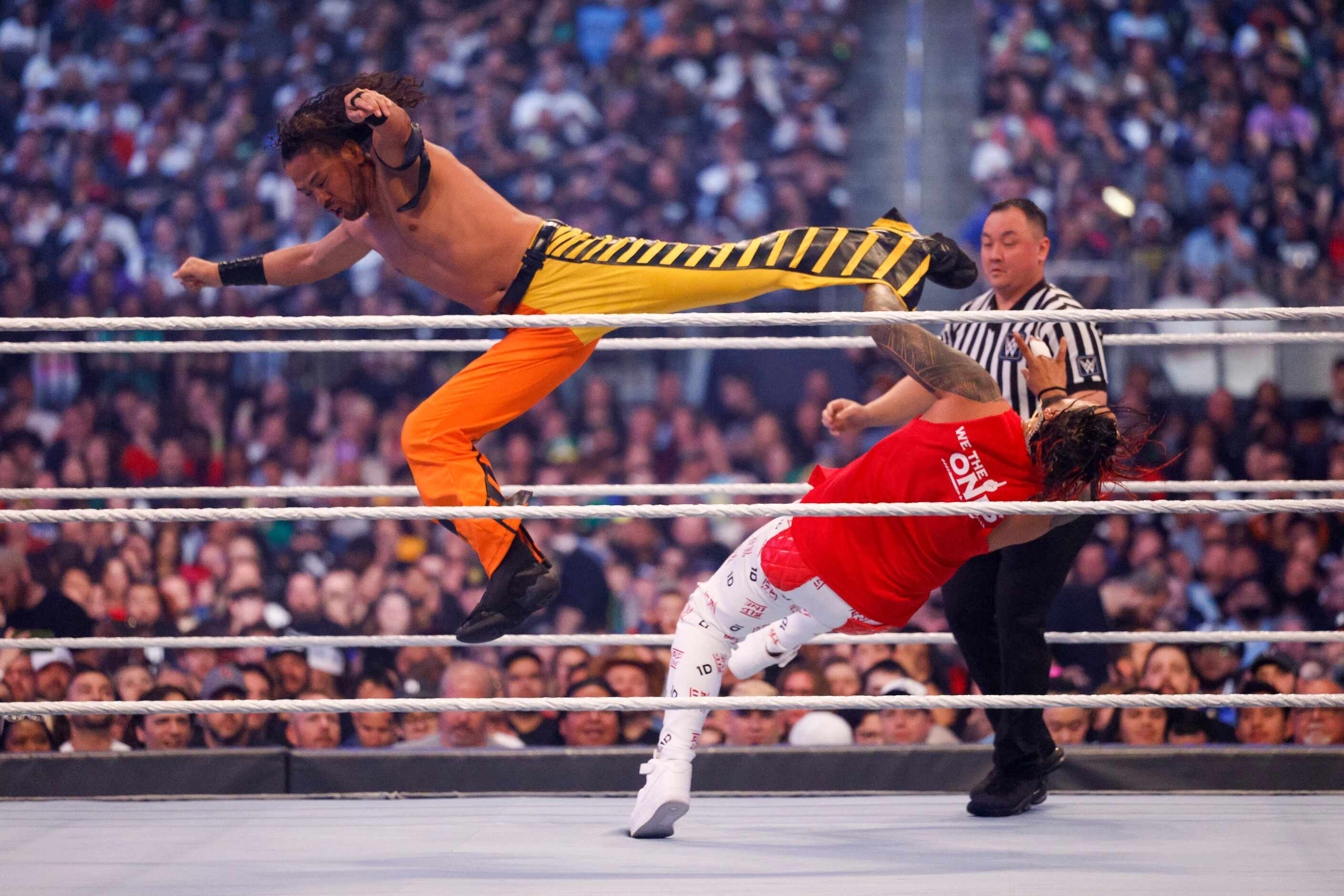 Shinsuke Nakamura (left) kicks Jimmy Uso during the SmackDown Tag Team Championship at...