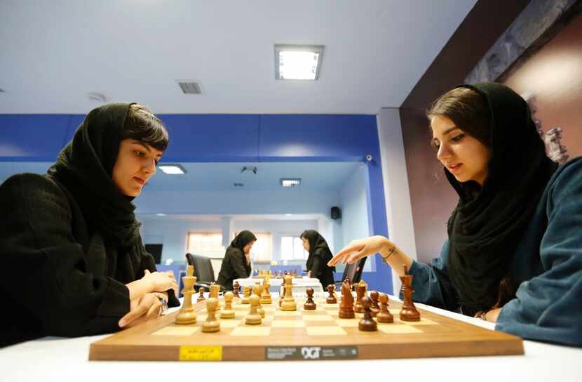 Iranian chess players Mitra Hejazipour (L) and Sara Khademalsharieh play at the Chess...