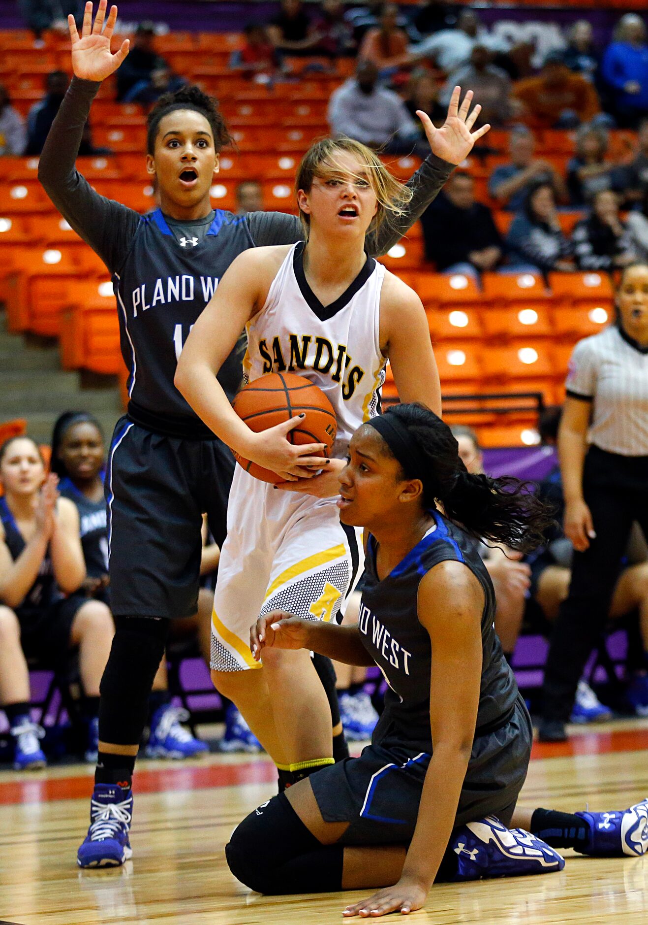 Plano West Callie Owens (13, back ) and Kyrie McNeil (33) react after they were called for a...