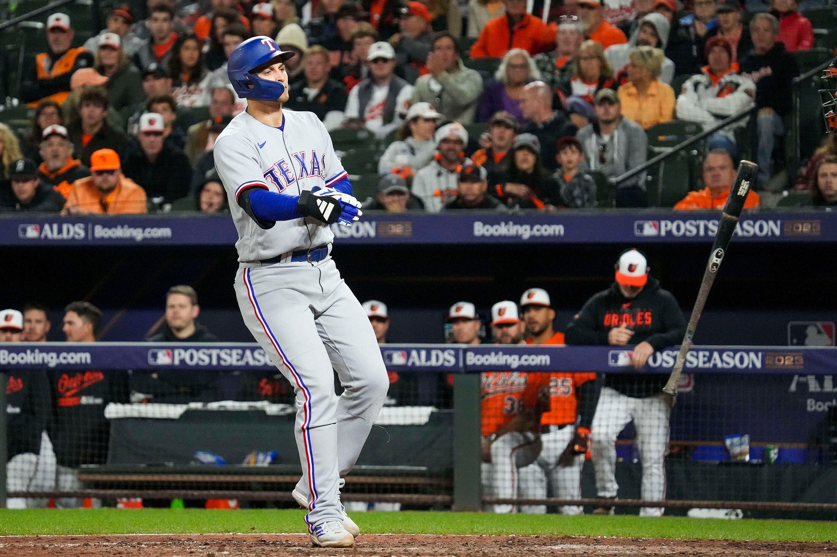 Texas Rangers shortstop Corey Seager tosses his bat toward the dugout as he heads for first...