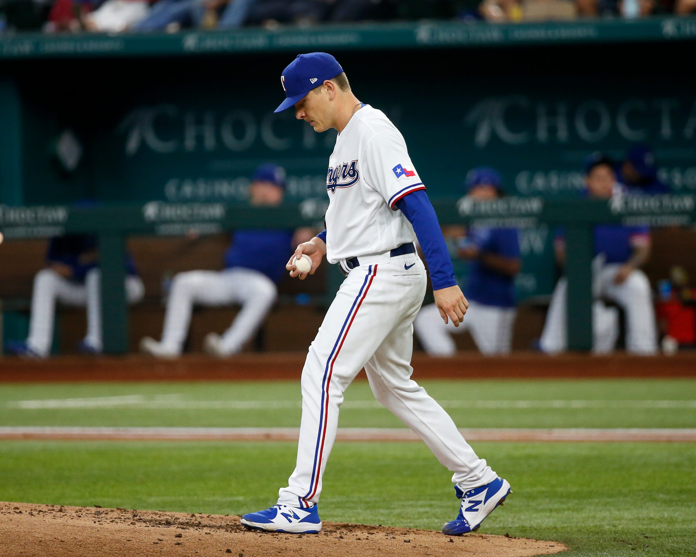 Texas Rangers starting pitcher Spencer Howard (31) walks back to the mound after giving up a...