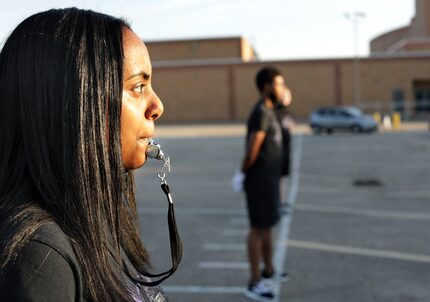 Junior drum major Aida Ewnetou practices her commands at Berkner High School. Even though...