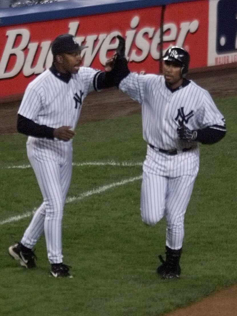 ORG XMIT: S1254D470_WIRE New York Yankees Bernie Williams, right, high fives third base...