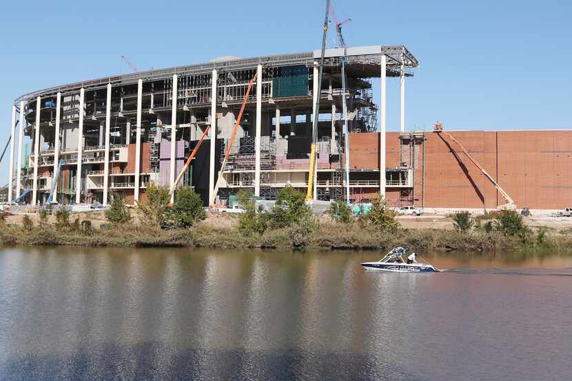 FILE - In this Nov. 13, 2013 photo, a boat floats past the new Baylor football stadium under...