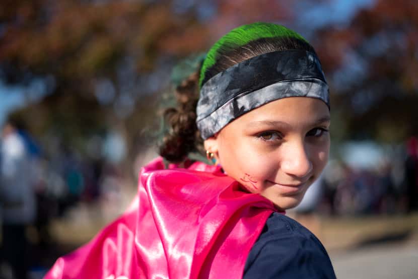 Isabella Robledo donned a cape after finishing the Girls on the Run DFW Metroplex 5K in...