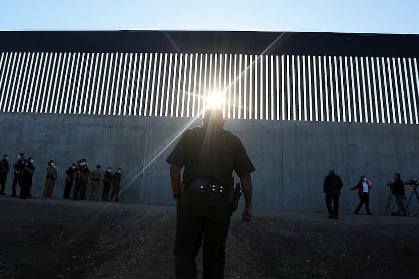 A U.S. Border Patrol agent approaches a new section of the border wall with Mexico. (Joel...