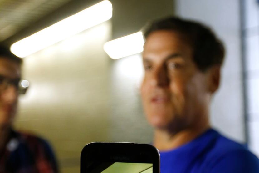 A member of the media uses a cell phone to record a video of Mark Cuban in an interview...