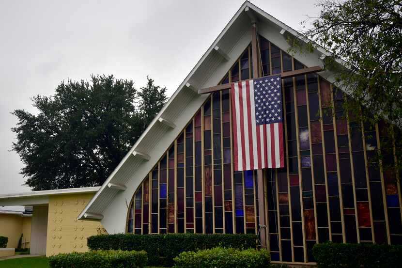 An American flag hangs on a cross outside of Precinct 4056 during Election Day Nov. 8, 2016,...
