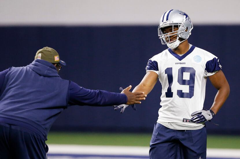 Dallas Cowboys running backs coach Gary Brown greets Dallas Cowboys receiver Amari Cooper...