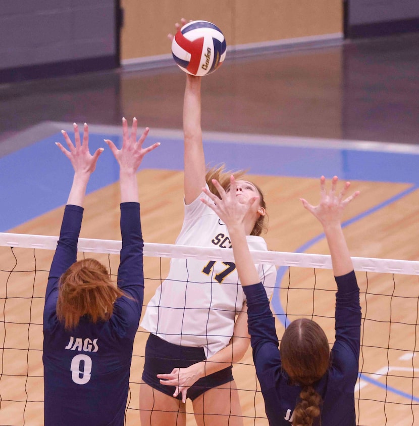 Highland Park’s Alex Richter (17) spikes the ball against Flower Mound’s Liz Goodspeed (3)...