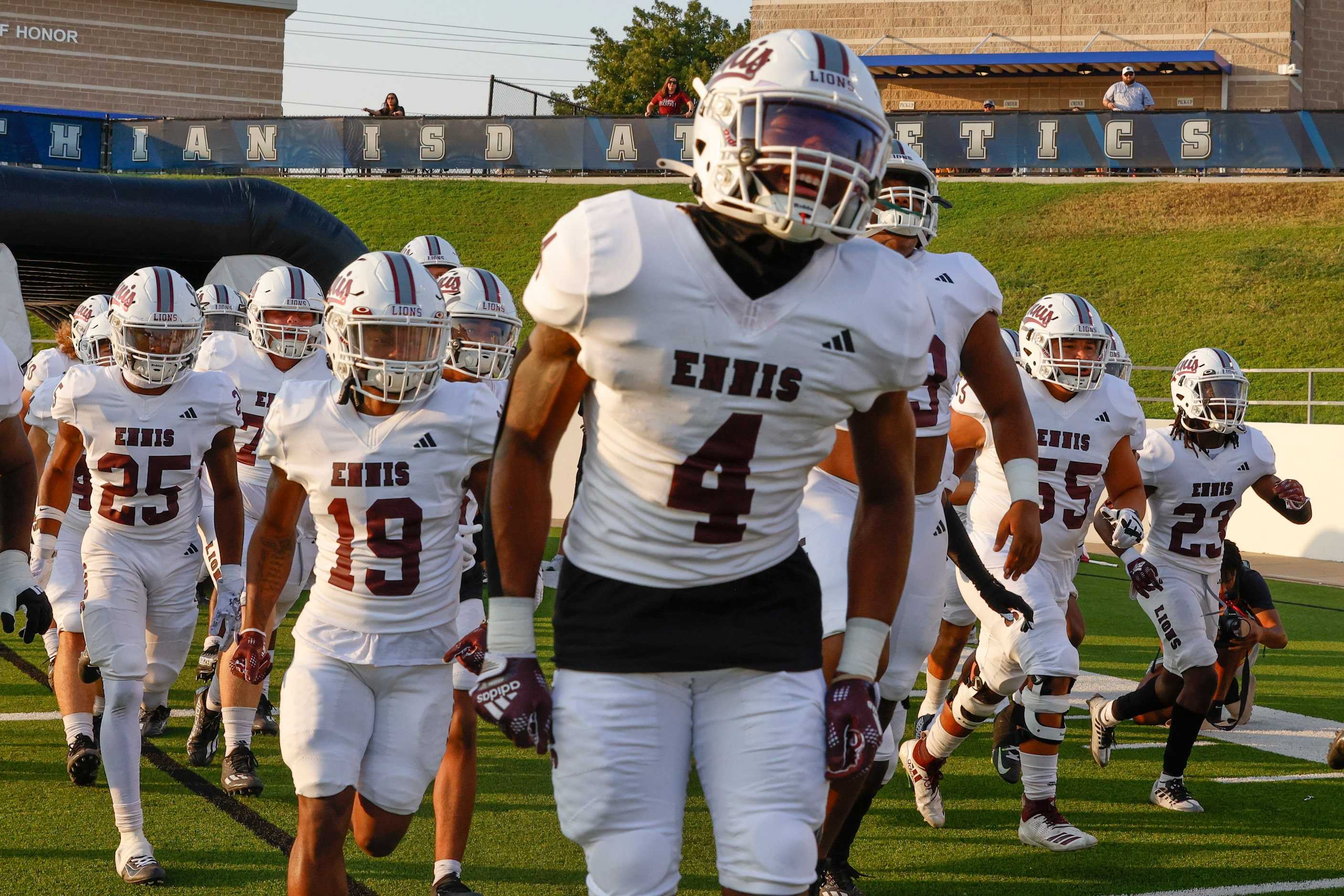 Ennis high school players enter the field ahead a football game against Midlothian High on...