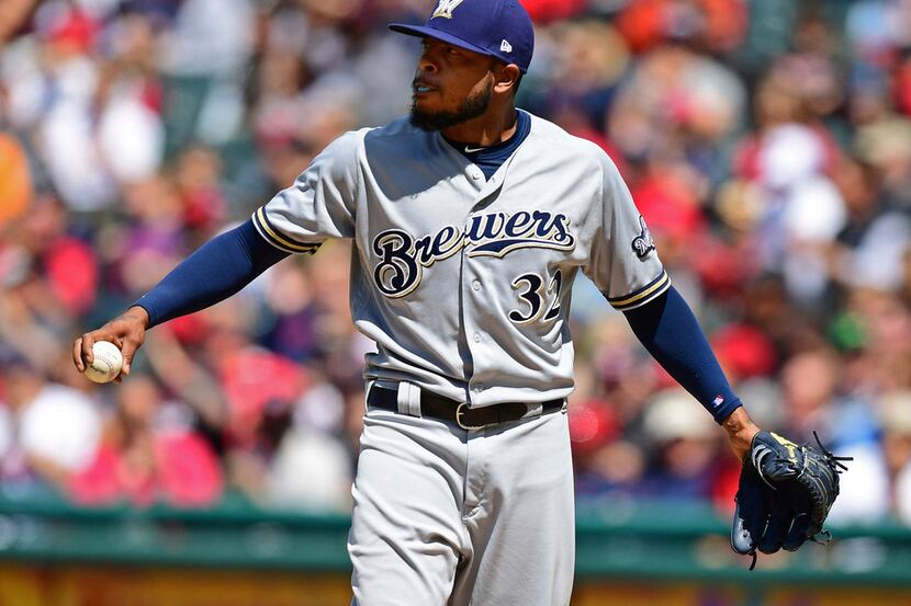 Milwaukee Brewers relief pitcher Jeremy Jeffress reacts after walking Cleveland Indians'...
