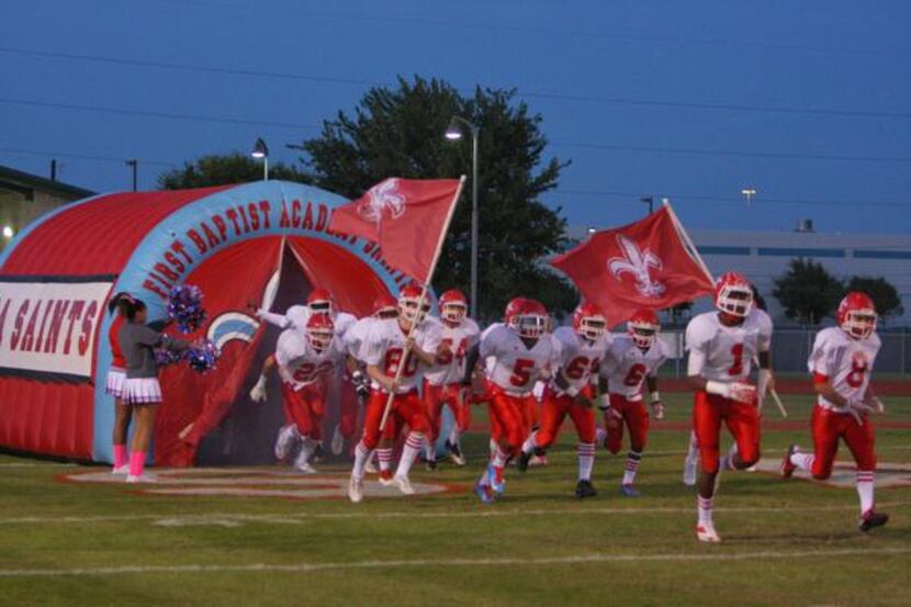 First Baptist runs on to the field to take on Tyler All Saints on Oct. 25 in its throwback...