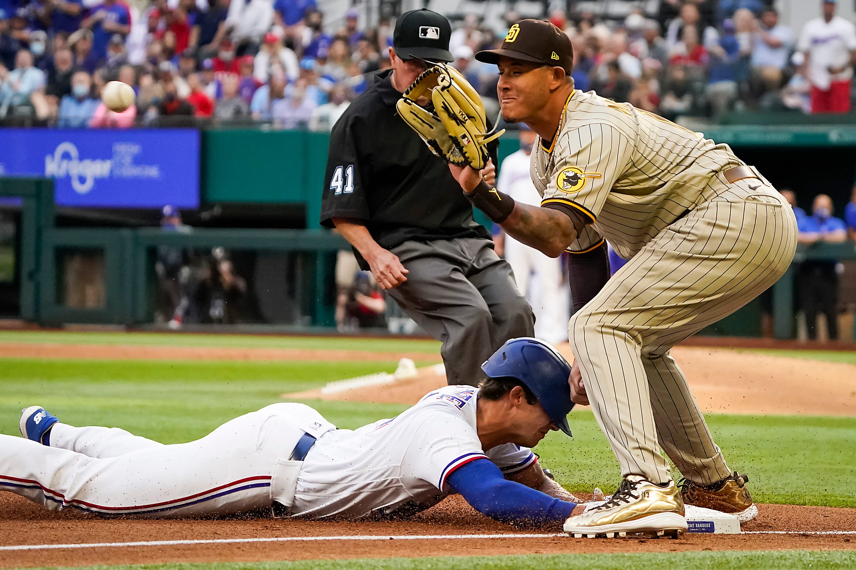 Texas Rangers outfielder Eli White is safe with an RBI triple ahead of the throw to San...