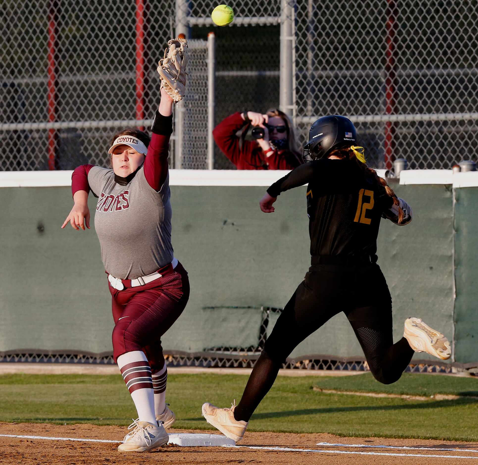Heritage first baseman Kailey Sweezey (23) was unable to hang onto the ball and Memorial’s...