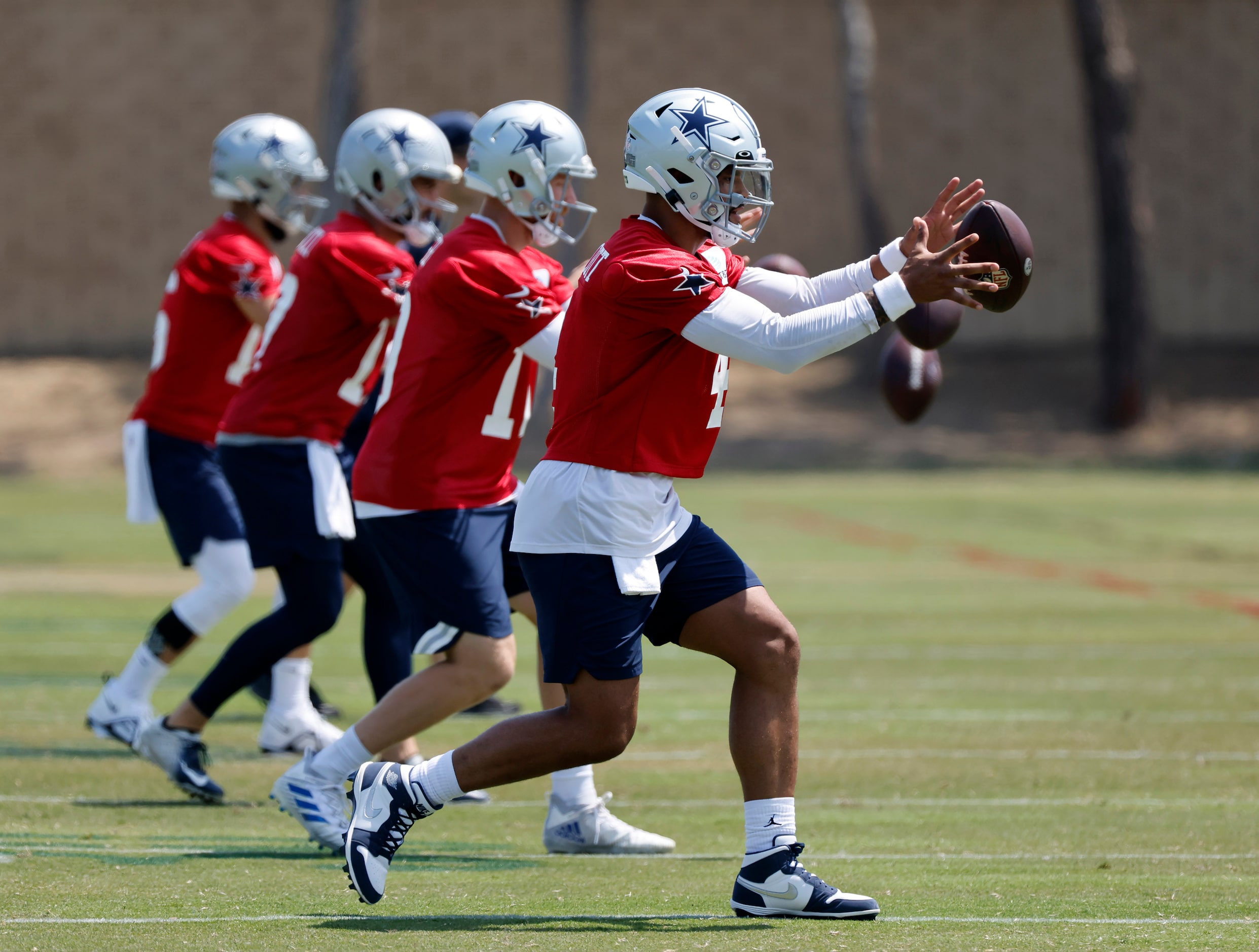 Dallas Cowboys quarterback Dak Prescott (4) and the other backups take snaps during the...