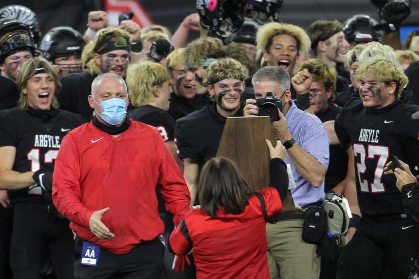 Argyle head coach Todd Rodgers steps up to accept the state championship trophy as his...