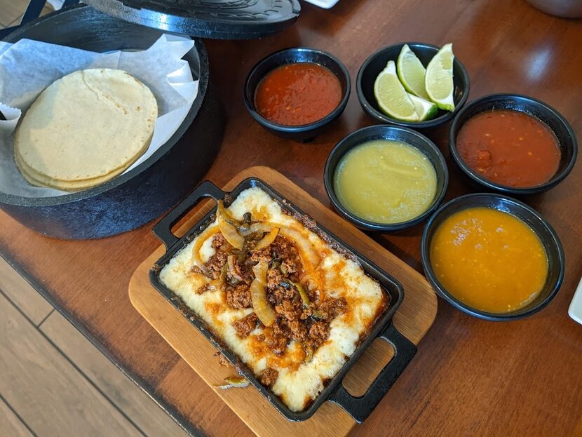 Queso fundido, tortillas and an armada of salsas at Los Molcajetes.