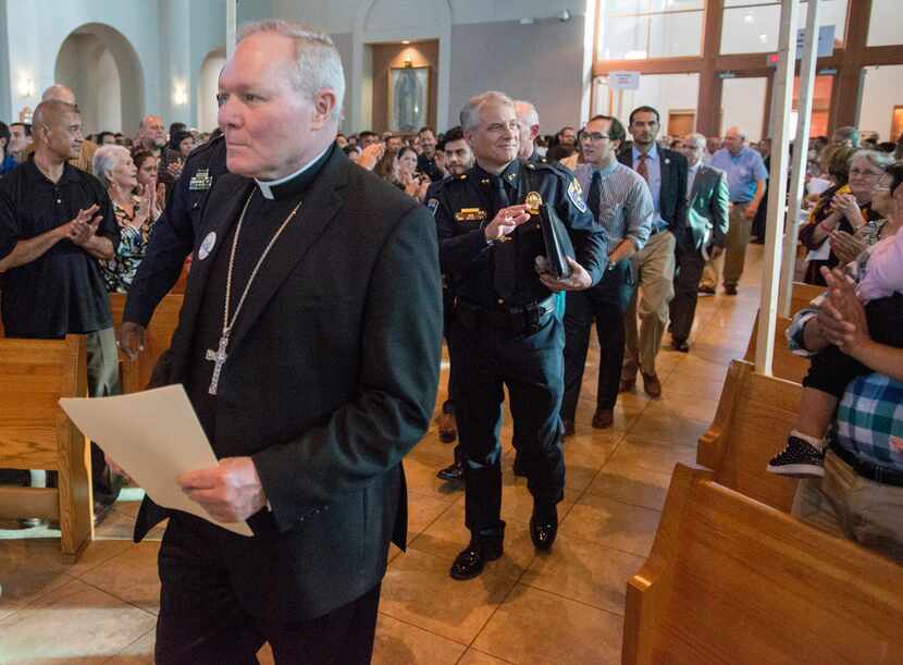 Catholic Diocese of Dallas Bishop Edward Burns led a procession of clergy, law enforcement...