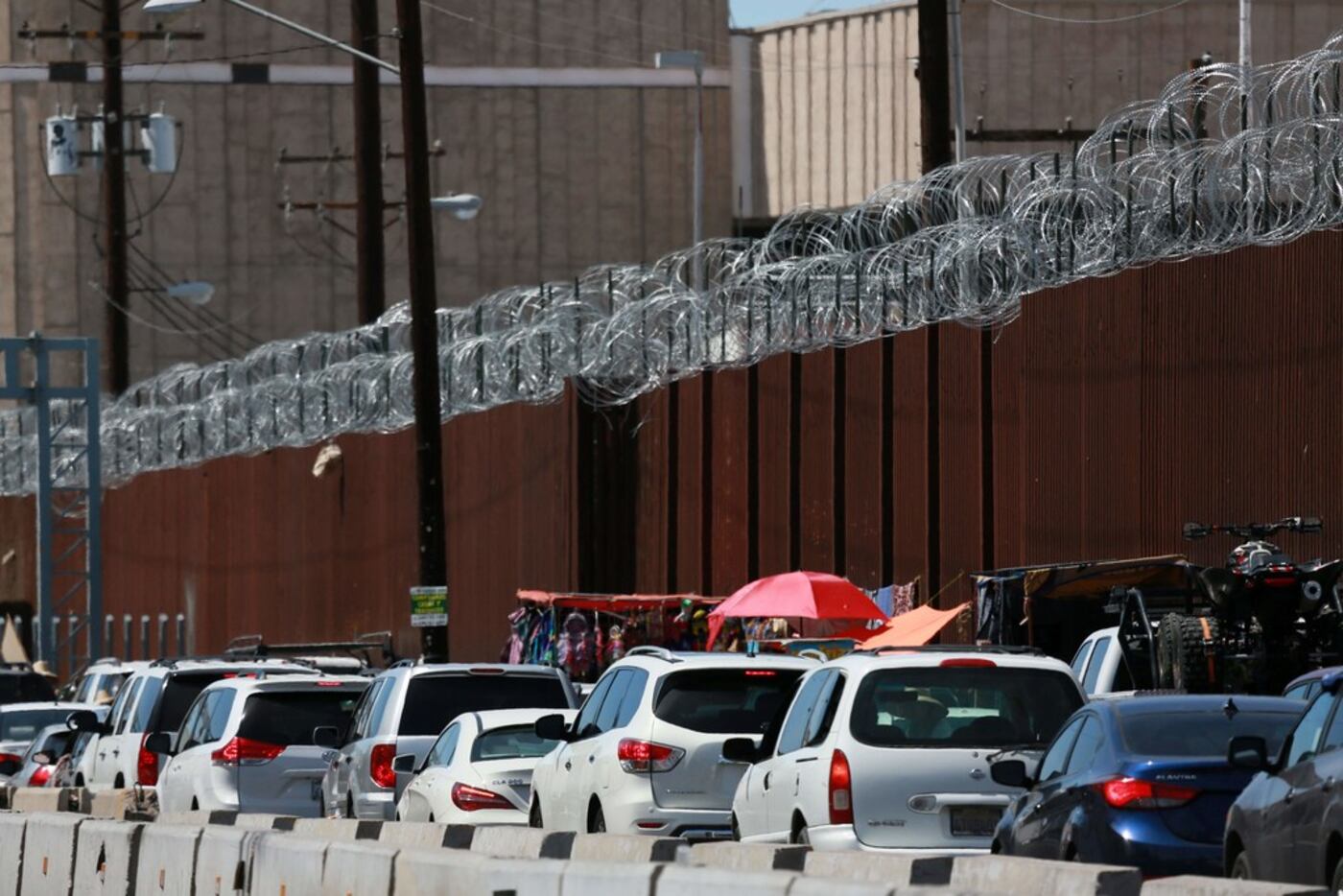 Motorists wait in line to cross the border into Calexico, Calif.