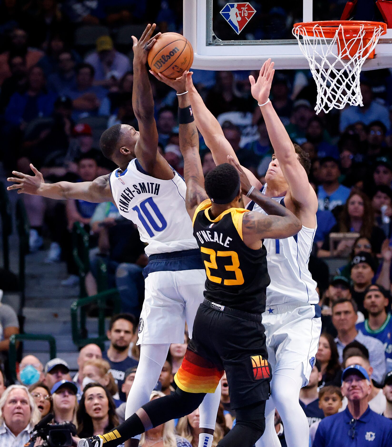 Dallas Mavericks forward Dorian Finney-Smith (10) and center Dwight Powell (7) block a shot...