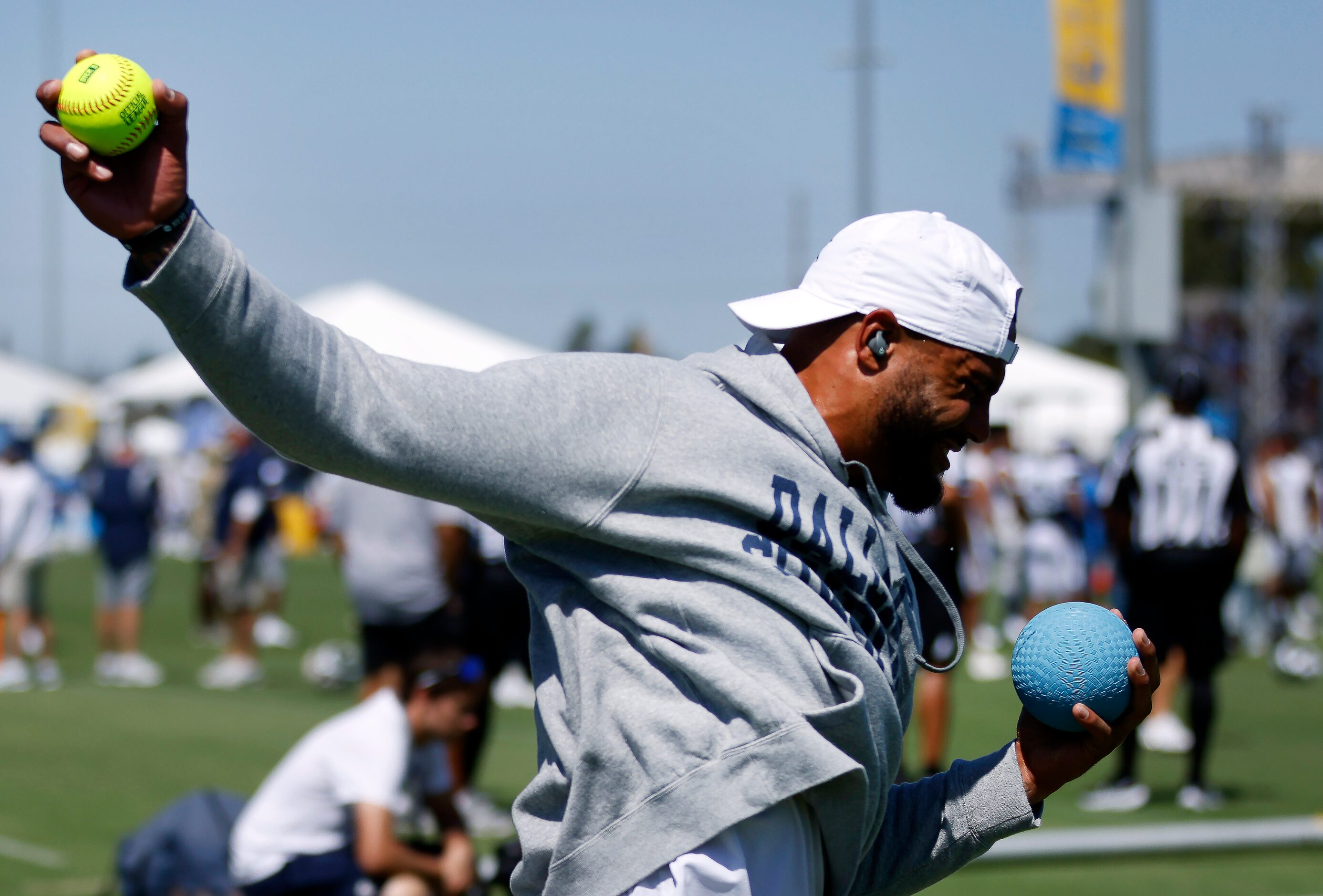 Dallas Cowboys quarterback Dak Prescott warms up with a softball and excise ball before a...